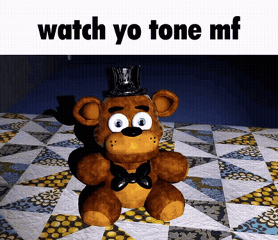Teddy Bear In Top Hat Sitting On Quilt GIF