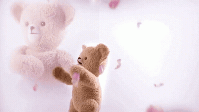 Teddy Bear On Pink Background With Falling Petals GIF
