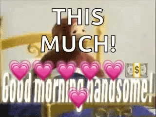 Teddy Bear Sitting On Bed With Hearts GIF