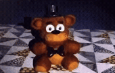 Teddy Bear Sitting On Quilt On Bed GIF