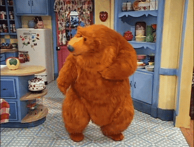 Teddy Bear Standing In Kitchen In Front Of Refrigerator And Shelves GIF