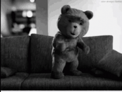 Teddy Bear Standing On Couch Black And White GIF