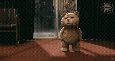 Teddy Bear Standing On Red Carpet In Front Of Window With Apple Logo GIF