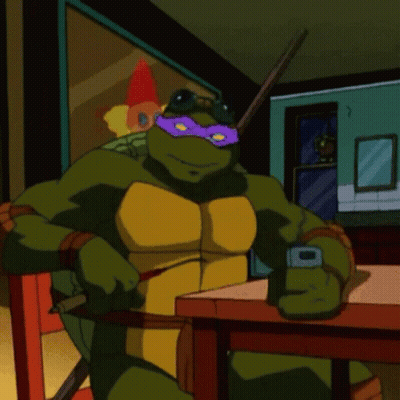 Teenage Mutant Ninja Turtle Sitting At Table With Cell Phone GIF