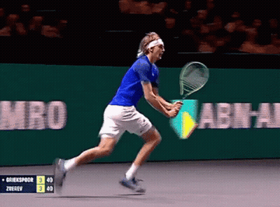 Tennis Player In Blue Shirt And White Shorts Running With Racquet GIF