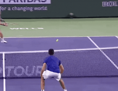 Tennis Player In Blue Shirt Serving Ball GIF
