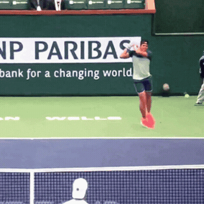 Tennis Player Jumping In Front Of Paribas Sign GIF