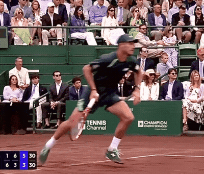 Tennis Player Running On Court In Front Of Tennis Channel Banner GIF