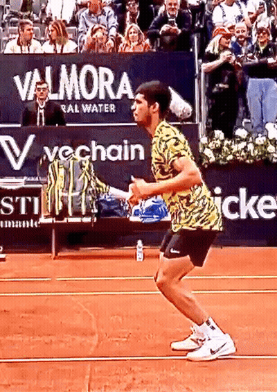 Tennis Player Squatting In Front Of Valmora Sign GIF
