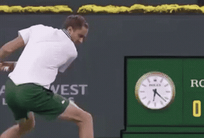 Tennis Player Swinging Racket At Ball On Court GIF