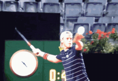 Tennis Player Swinging Racket In Front Of Clock Saying 0:04 GIF