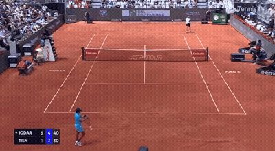 Tennis Player Swinging Racket In Front Of EA7 Sign GIF
