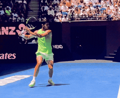 Tennis Player Swinging Racket In Front Of Nexo Sign GIF