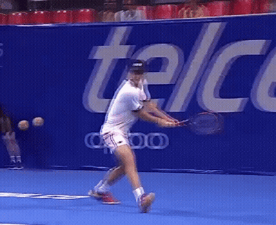 Tennis Player Swinging Racket In Front Of Telcel Sign GIF