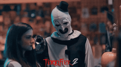 Terrifier 2 Poster Clown Standing Next To Girl GIF