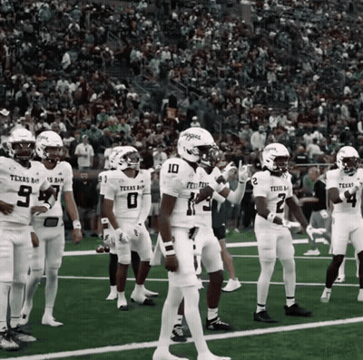 Texas A&M Football Players Standing On Field GIF