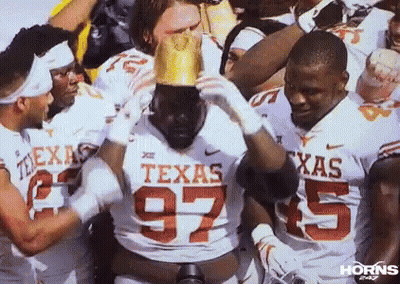 Texas Football Players Holding Crown On Head GIF