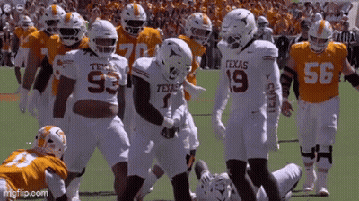 Texas Football Players Standing On Field GIF