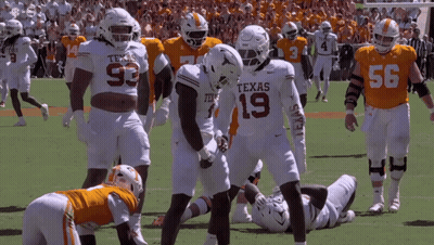Texas Football Players Standing On Field GIF