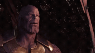 Thanos From Avengers : Age Of Ultron Is Standing In The Dark With His Eyes Closed And A Beard . GIF