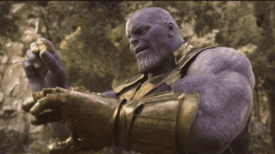 Thanos From Avengers Infinity War Is Holding A Gold Ring In His Hand . GIF