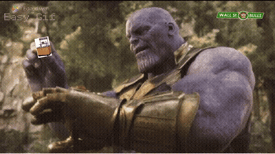 Thanos Holding Lighter In Front Of Wall Street Bulls Sign GIF