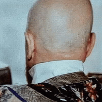 The Back Of A Bald Man 'S Head With A Floral Jacket On GIF