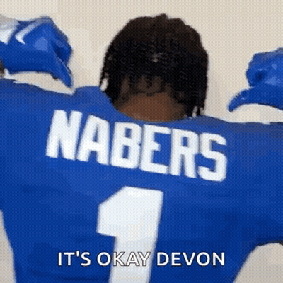 The Back Of A Football Player Wearing A Blue Jersey With The Name Nabers On The Back . GIF
