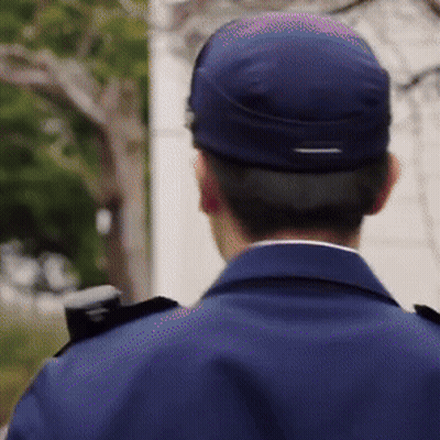 The Back Of A Man Wearing A Blue Uniform And A Blue Hat GIF
