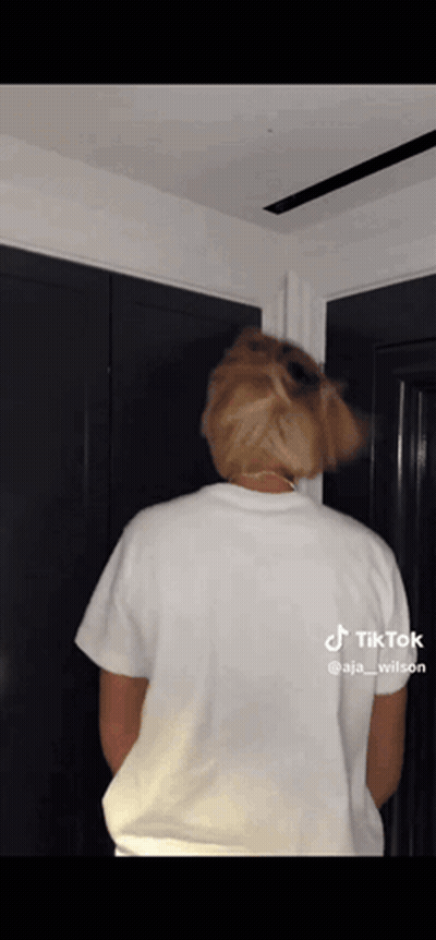 The Back Of A Person Wearing A White T-Shirt Is Shown GIF