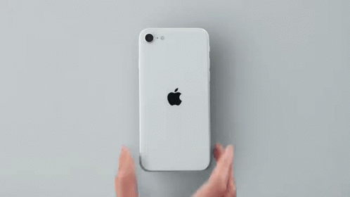 The Back Of A White Apple Iphone Se Is Shown On A Gray Surface . GIF