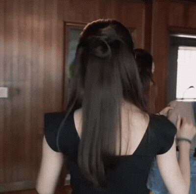 The Back Of A Woman With Long Black Hair GIF