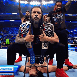 The Bloodline Roman Reigns Sitting Over Drew McIntyre GIF