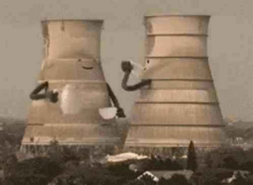 The Cooling Towers Of A Power Plant Are Being Demolished . GIF
