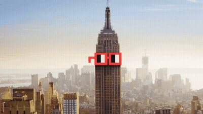 The Empire State Building Is Surrounded By A City Skyline And Has A Pair Of Red Glasses On The Top Of It GIF