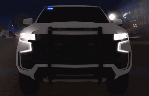 The Front Of A White Truck With Red And Blue Lights On GIF