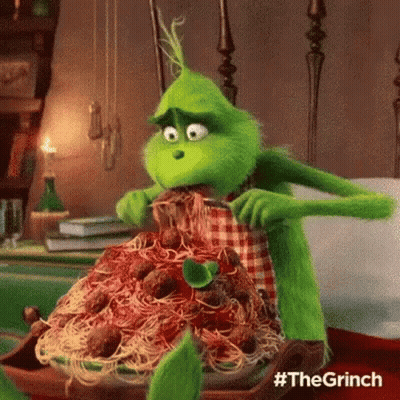 The Grinch From The Movie The Grinch Is Eating Spaghetti And Meatballs With A Fork . GIF