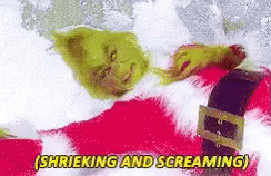The Grinch Is Laying In The Snow And Screaming While Wearing A Santa Suit . GIF