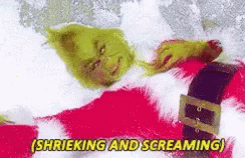 The Grinch Is Laying In The Snow And Screaming While Wearing A Santa Suit . GIF