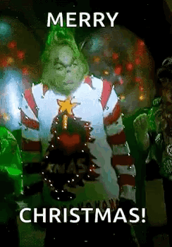 The Grinch Is Wearing A Christmas Sweater And Holding A Christmas Tree In His Hand . GIF