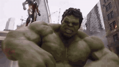 The Hulk Is Fighting Iron Man In A City In A Superhero Movie . GIF