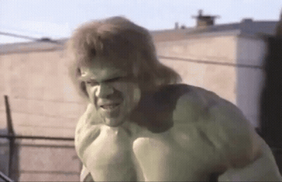 The Hulk Is Standing In Front Of A Building With A Serious Look On His Face . GIF