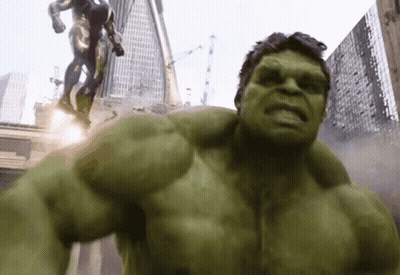 The Hulk Is Standing In Front Of A Statue Of A Man GIF