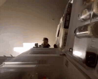 The Inside Of A Refrigerator With The Door Open And A Person Standing Behind It GIF