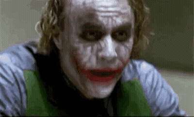 The Joker From The Movie The Dark Knight Is Making A Funny Face While Looking At The Camera . GIF