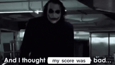 The Joker From The Movie The Dark Knight Rises Is Standing In A Dark Room . GIF