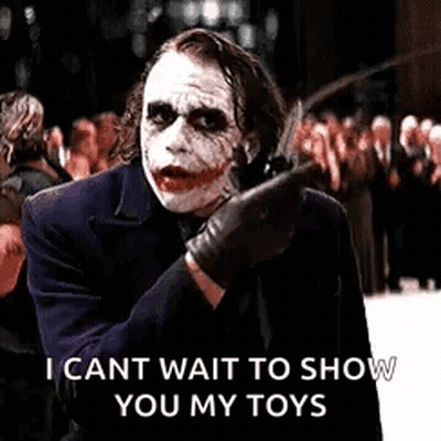 The Joker Is Holding A Knife And Pointing At Someone . GIF