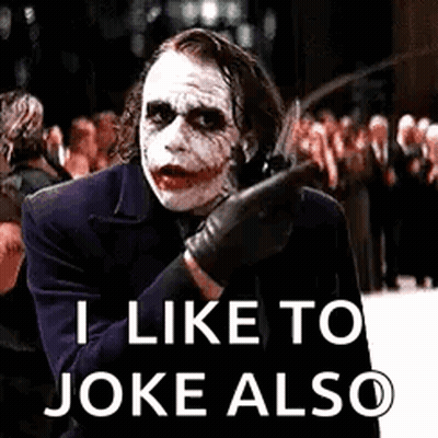 The Joker Is Holding A Knife And Says `` I Like To Joke Also '' While Standing In Front Of A Crowd . GIF