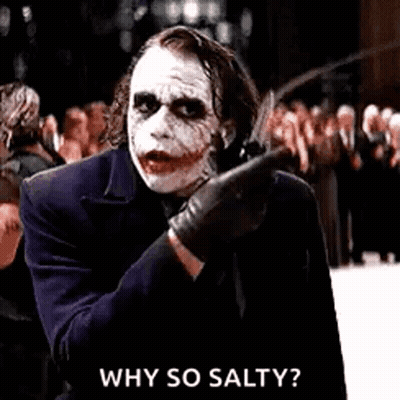The Joker Is Holding A Knife In His Hand And Pointing At Someone . GIF