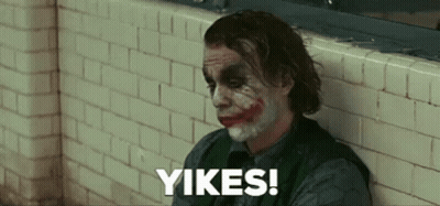 The Joker Is Leaning Against A Brick Wall And Saying Yikes ! GIF
